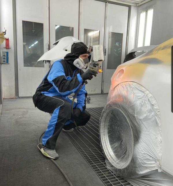 man in luma iii premium spray suit spray painting SEMA car